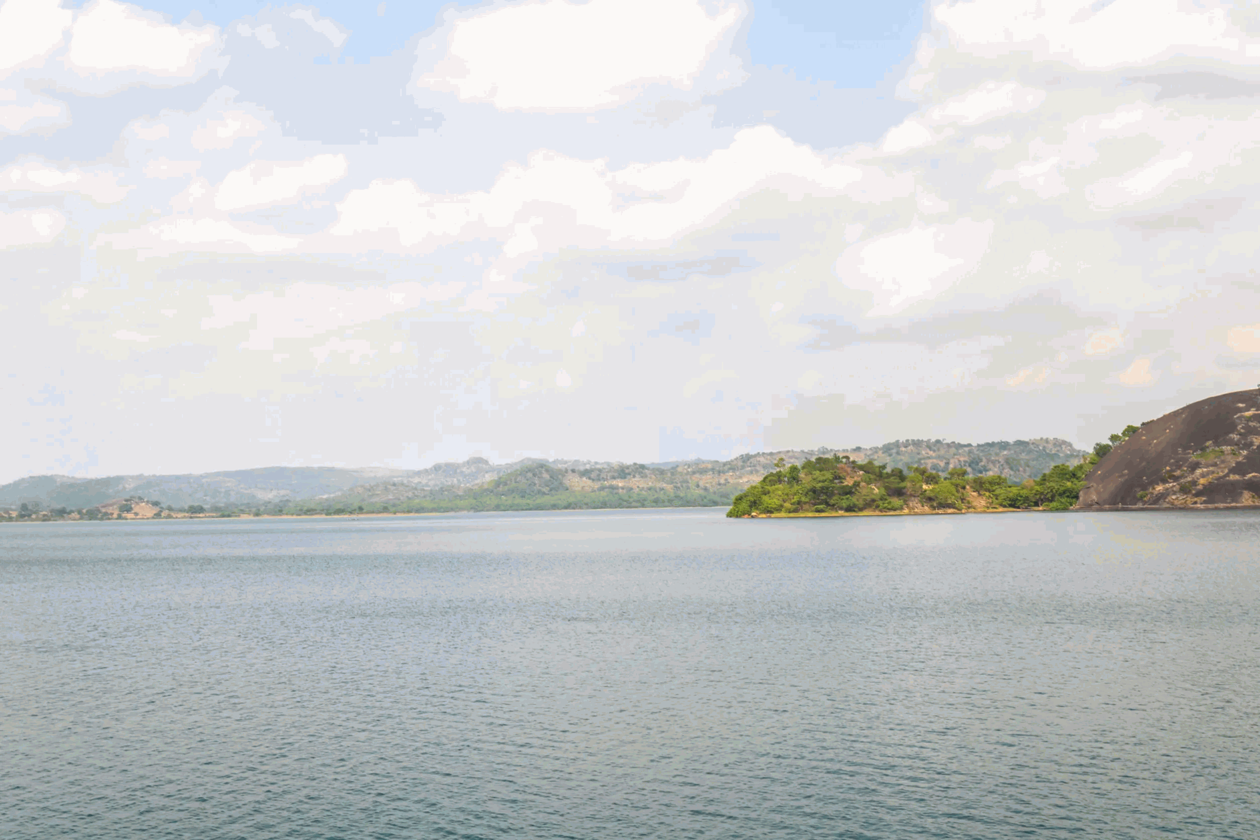 beautiful picturesque view of a mountain side dwelling with trees rock