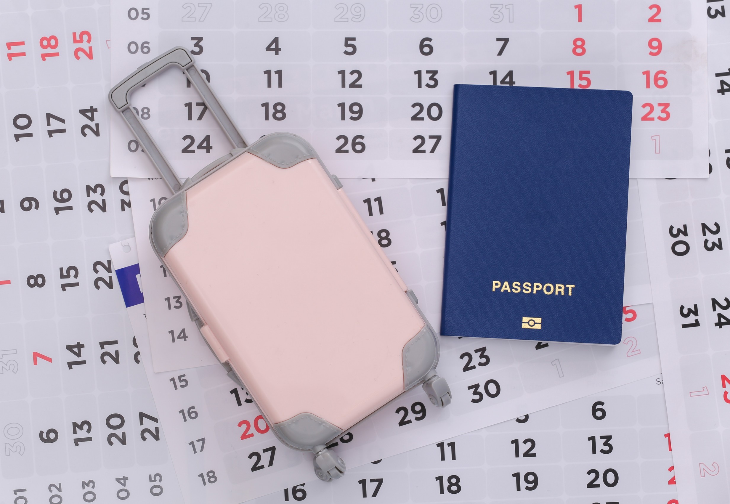 Passport And Luggage On The Monthly Calendar